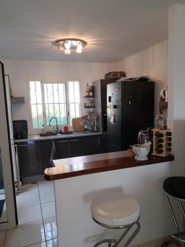 eine Küche mit Theke und Kühlschrank in der Unterkunft Chez NOUS in Saint-Paul