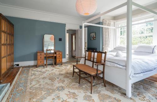 a bedroom with a bed and a desk and a chair at Windy Ridge in Bembridge