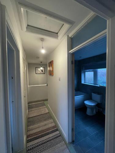 - un couloir menant à une salle de bains pourvue de toilettes dans l'établissement Musden Walk individual rooms, à Manchester