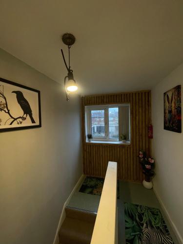 a small room with a bench and a window at Musden Walk individual rooms in Manchester