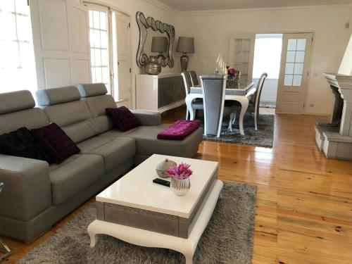 a living room with a couch and a table at Refugio D Alecrim in Paredes