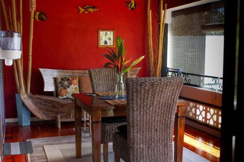 a dining room with a wooden table and chairs at Nid'Aigle Lodge in Anse Possession