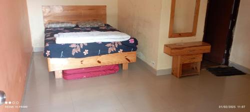 a bedroom with a bed and a mirror and a table at SR lodge in Seringapatam