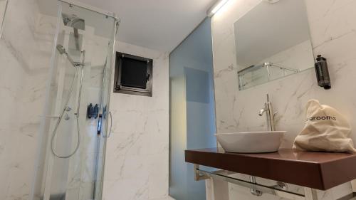 a bathroom with a sink and a shower at Hotel Barrio Húmedo by gaiarooms in León