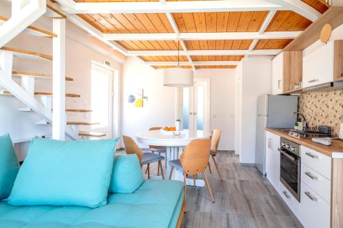 a kitchen and living room with a couch and a table at ALMA HILLS Gialova in Gialova