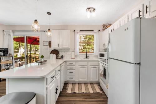 a kitchen with white cabinets and a white refrigerator at 3 bedroom Rental pet friendly, fireplace, hot tub, near ski resorts in Albrightsville