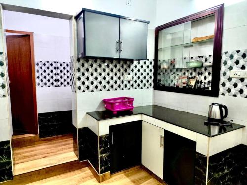 a kitchen with a pink bowl on a counter at KP Home in Tellicherry