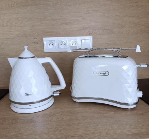 a toaster and a tea kettle sitting on a counter at Grand Apartman - 5 Star Luxury Podhajska Apartman in Podhájska
