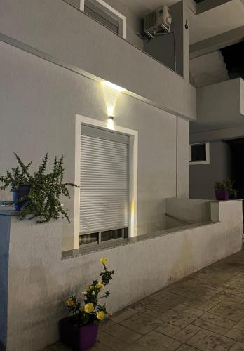 a building with a window with a window blind at Xhefri's Apartments in Vlorë