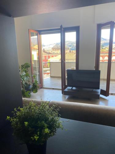 a living room with a television and a balcony at Sium's Suite Apartment 2 in Como
