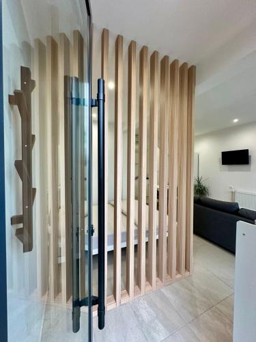 a room with a glass partition with a bed in it at Skopje Home 19 in Skopje