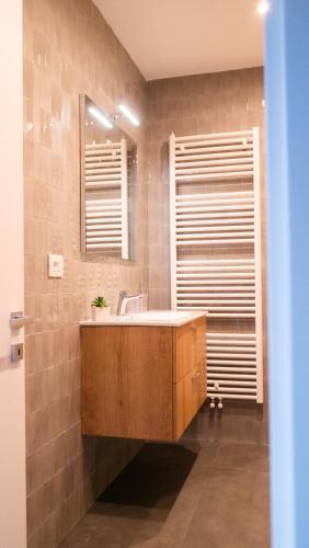 a bathroom with a sink and a mirror at Appartamento Angeli in Levico Terme