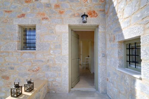 a hallway of a stone building with two windows at Nikoloudi Estate in Agios Nikolaos