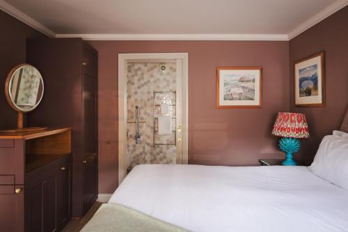 a bedroom with a white bed and a shower at The Beeley Inn - Chatsworth in Beeley