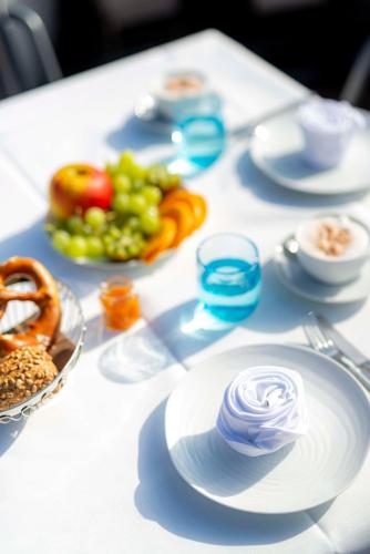 a white table with plates of food on it at Hotel Schindlerhof in Nürnberg