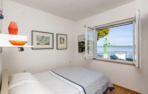 a bedroom with a bed and a window at Beautiful Villa Zman near sea in Dugi Otok in Žman