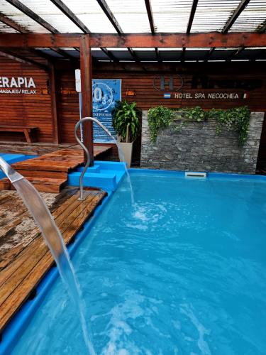 a swimming pool with a water fountain at Hotel Firenze in Necochea