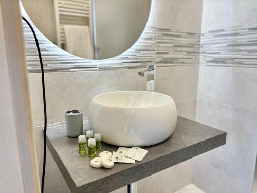 a bathroom with a white sink and a mirror at Romano's Luxury Stay b&b Bari in Bari