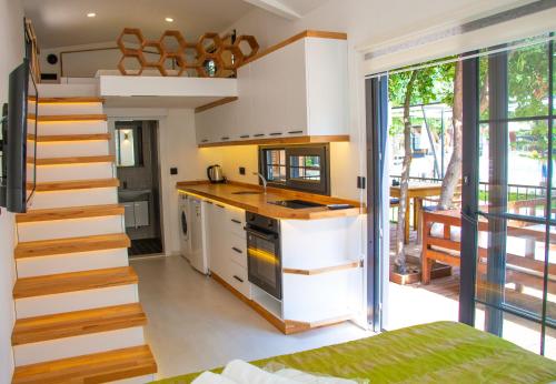 a kitchen with a staircase next to a room at Gizli Cennet Villages Hotel in Fethiye