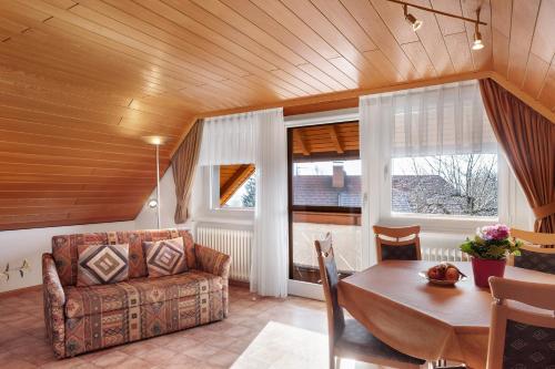 a living room with a couch and a table at Haus Ingrid in Schluchsee