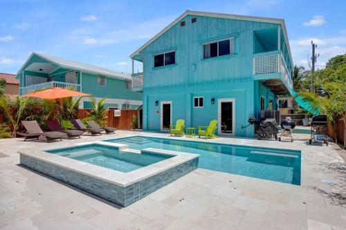 a house with a swimming pool in front of a house at Key Largo Home with Spa and Pool in Key Largo