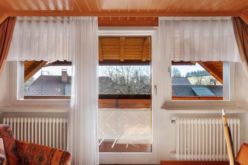 a window with white curtains in a room at Haus Ingrid in Schluchsee