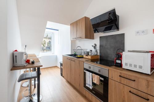 Una cocina o cocineta en NOMAD APARTMENTS - Vue collégiale