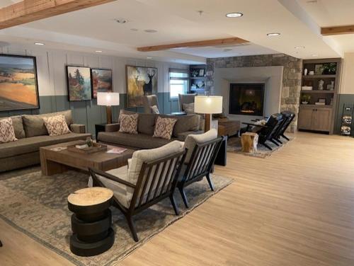 a large living room with couches and a fireplace at Sweetwater Lift Lodge in Park City