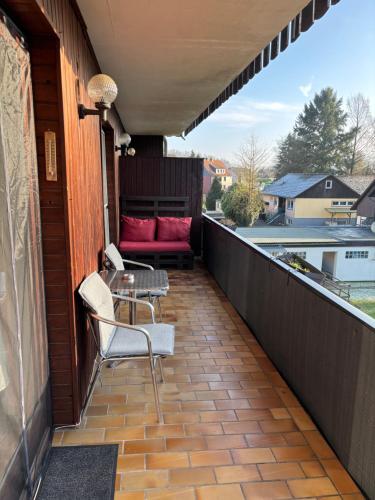 a patio with two chairs and a table on a balcony at Henriette in Walkenried