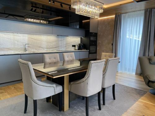 a dining room with a table and chairs at Luxury Chalets Lesná in Nová Lesná