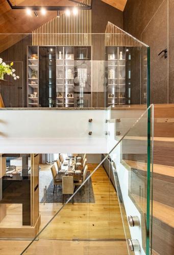 a dining room with a table and a glass wall at Luxury Chalets Lesná in Nová Lesná