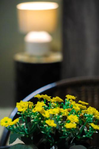 a bunch of yellow flowers sitting in a bowl at Green Crab House Stay in Ban Ao Makham
