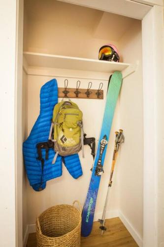 a shelf with a backpack and ski equipment in a room at Big Sky Resort and Lone Peak Views in Big Sky