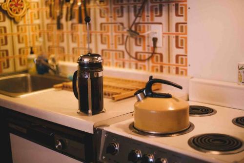 a tea kettle sitting on top of a stove at Innsbruck Walkable to Big Sky Resort in Big Sky
