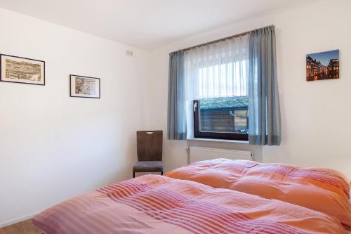a bedroom with a bed and a window at Haus Ingrid in Schluchsee