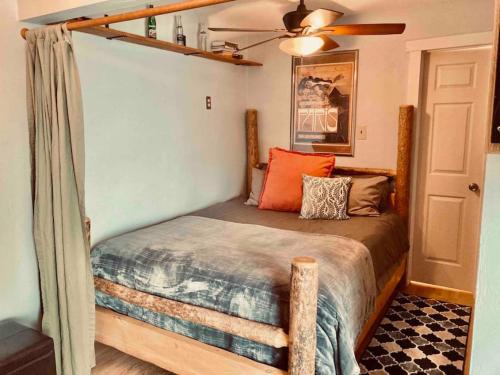 a bed in a room with a ceiling fan at Ski Bunny Studio Walkable to Ski Lifts in Big Sky