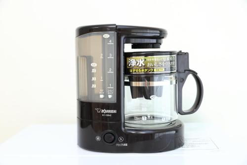 a black coffee maker with a blender on a white background at サザンコースト湘南 in Chigasaki