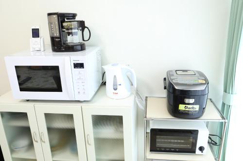 a counter with a microwave and a blender and a toaster at サザンコースト湘南 in Chigasaki