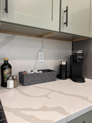 a kitchen with white cabinets and a counter top at Juneau Family Friendly Getaway 301 in Juneau
