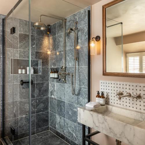 a bathroom with a shower and a sink at Louma Country Hotel in Wootton Fitzpaine