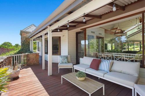 a patio with a couch and a table on a deck at Escape to Darlington Bliss Serene Nature Retreat in Darlington
