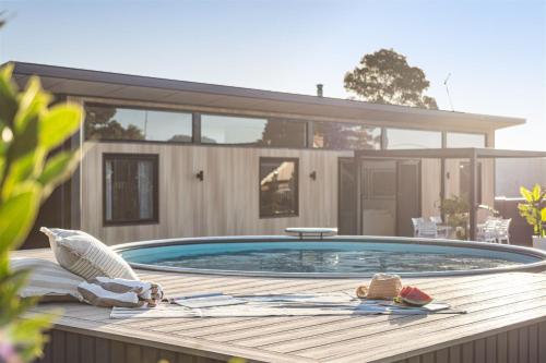a swimming pool in front of a house at Cabin 21 - Luxury Wellness Escape - Town Central in Margaret River Town