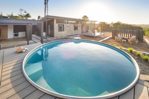 a large swimming pool on a wooden deck next to a house at Cabin 21 - Luxury Wellness Escape - Town Central in Margaret River Town