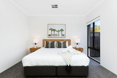 a bedroom with a large bed and a window at Spacious and modern Dianella in Perth