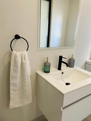 プレトリアにある1 bedroom- The Blyde by Givenの白い洗面台と鏡のあるバスルーム