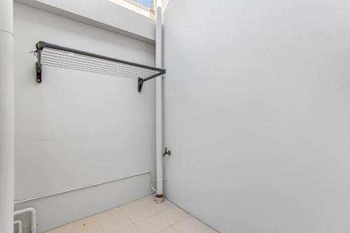 a white wall with a door in a room at Luxury Coastal Townhouse 130m to Cottesloe Beach in Perth