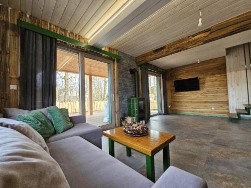 a living room with a couch and a table at Gabrysiówka in Sztabin