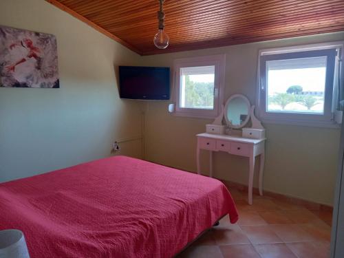 a bedroom with a pink bed and a mirror at Beach house in Nea Potidaea