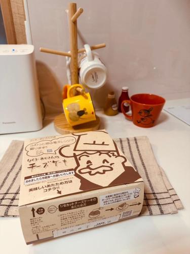 a pizza box sitting on top of a counter at 8Home Kids House in Osaka