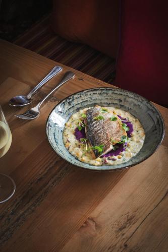 a plate of food on top of a wooden table at The Beeley Inn - Chatsworth in Beeley